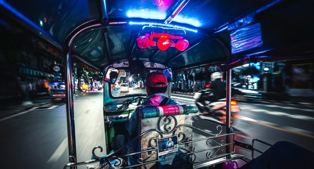 people riding on blue and white car during nighttime