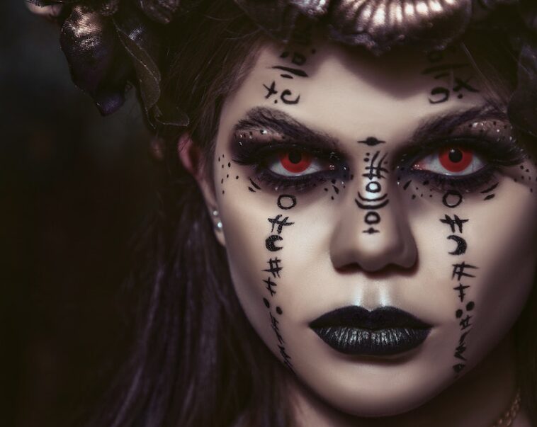 Spooky woman with makeup of spells