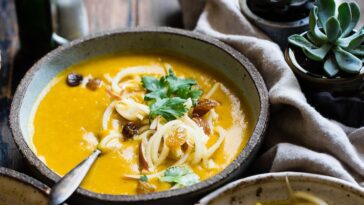 three noodle dishes with orange sauces in food photography