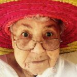 woman using eyeglasses and wearing hat