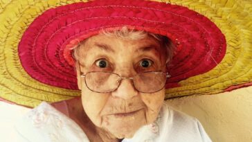 woman using eyeglasses and wearing hat