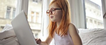 A Girl Watching Movie On Computer Laptop