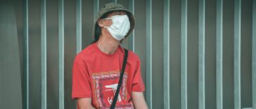 man in red crew neck t-shirt wearing white sunglasses sitting on black chair