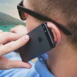 person holding black iPhone 5s