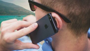 person holding black iPhone 5s